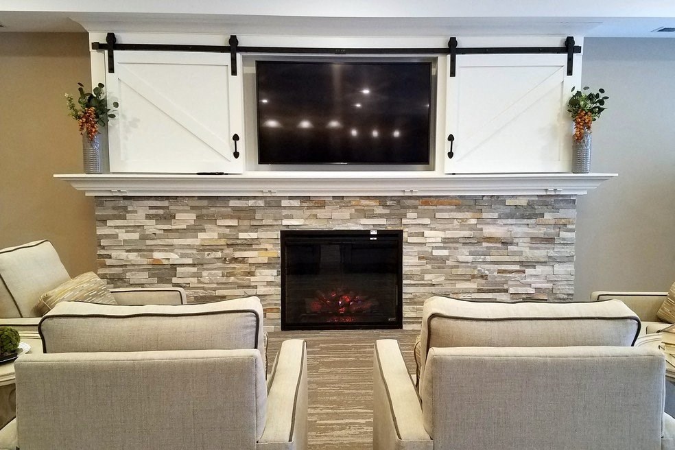 a living room with a fireplace and a tv