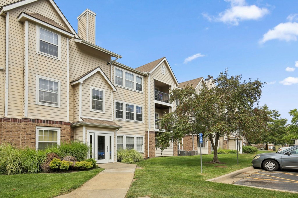 A building with a blue sky and clouds in the background.