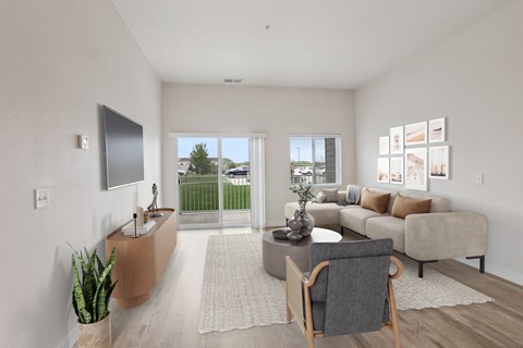 A living room with a grey couch, a wooden table, and a television on the wall.