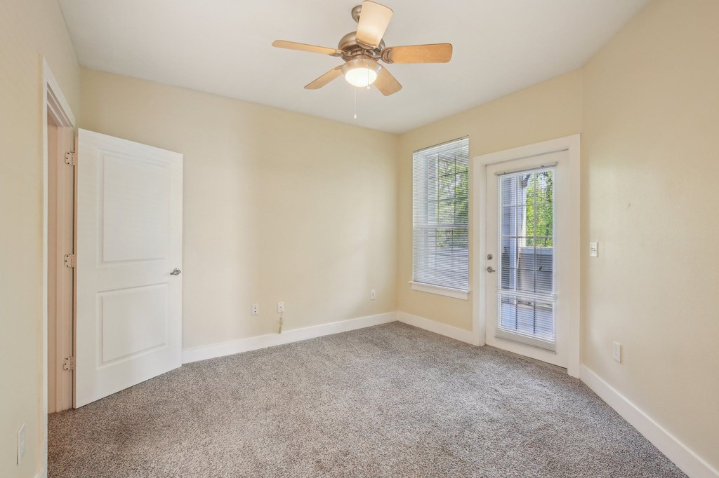 A room with a ceiling fan and carpeted floor. at Province of Briarcliff Apartments, Kansas City, MO