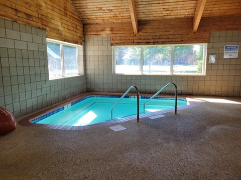 a swimming pool inside of a building with a pool