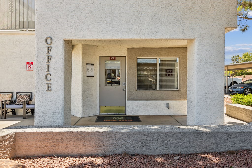 a white building with a glass door and a sign on the side of it