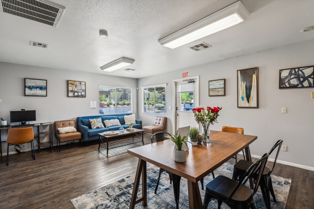 a dining room with a table and chairs and a living room with couches