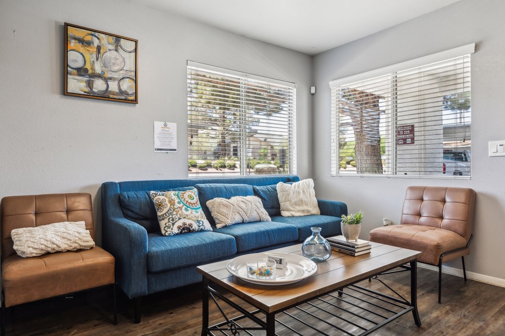 a living room with a blue couch and a coffee table