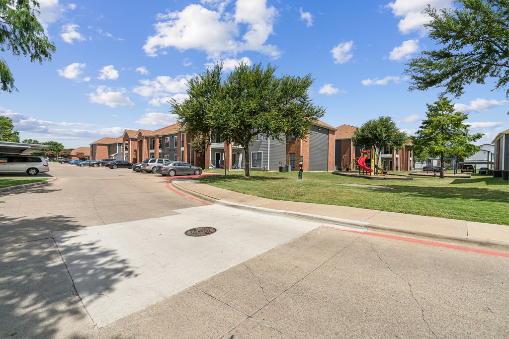 a city street with a row of buildings on the side of the road