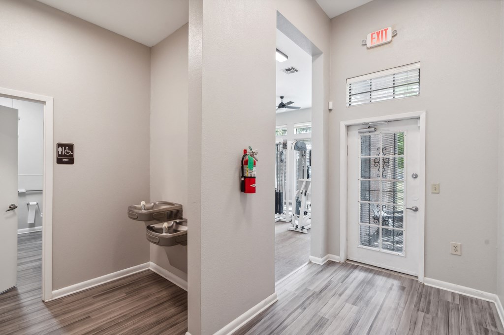 the entrance to a home with a door to a bathroom and a entrance hall with