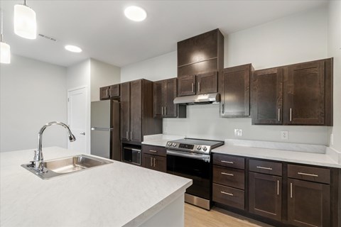 A kitchen with brown cabinets and a white countertop.