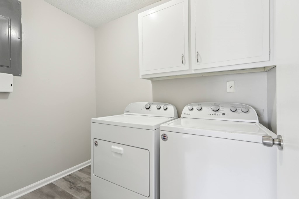 A white washer and dryer in a laundry room.