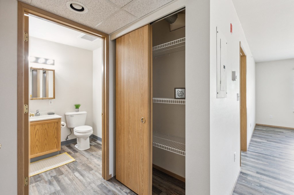 a bathroom with a toilet and a wooden door