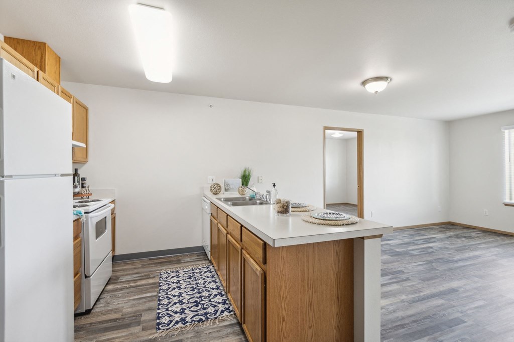 a kitchen with an island and a white refrigerator