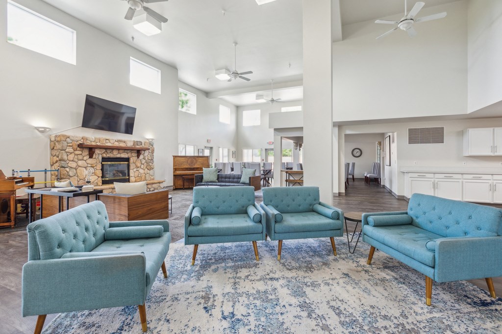 the preserve at ballantyne commons community living room with blue chairs and a fireplace