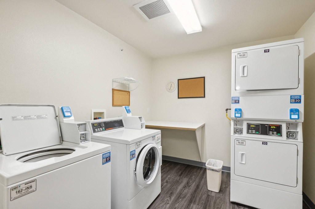 a laundry room with washes and dryers and a counter with a washer