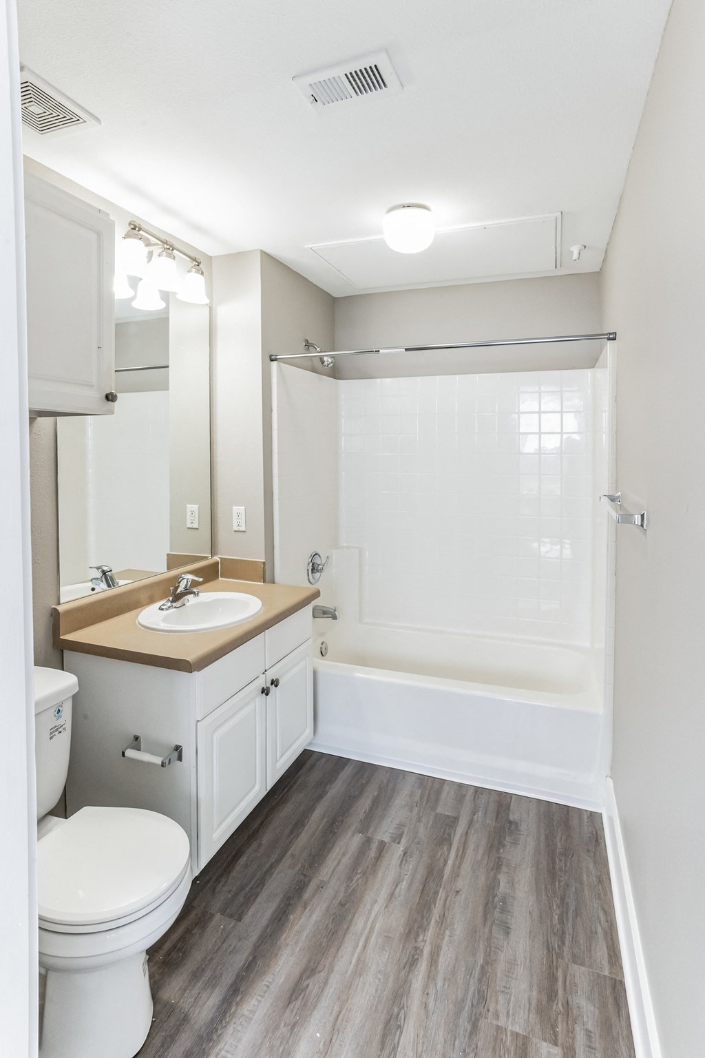 an empty bathroom with a sink toilet and shower at Province of Briarcliff Apartments, Kansas City, MO