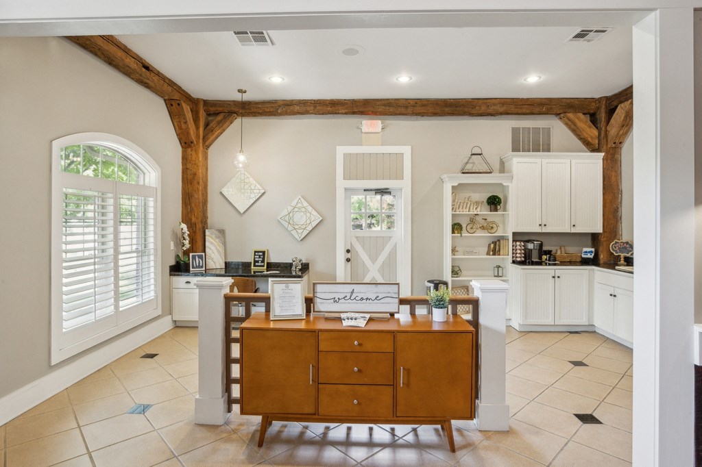a kitchen with white cabinets and a wooden island with a wooden desk at Province of Briarcliff Apartments, Kansas City, Missouri