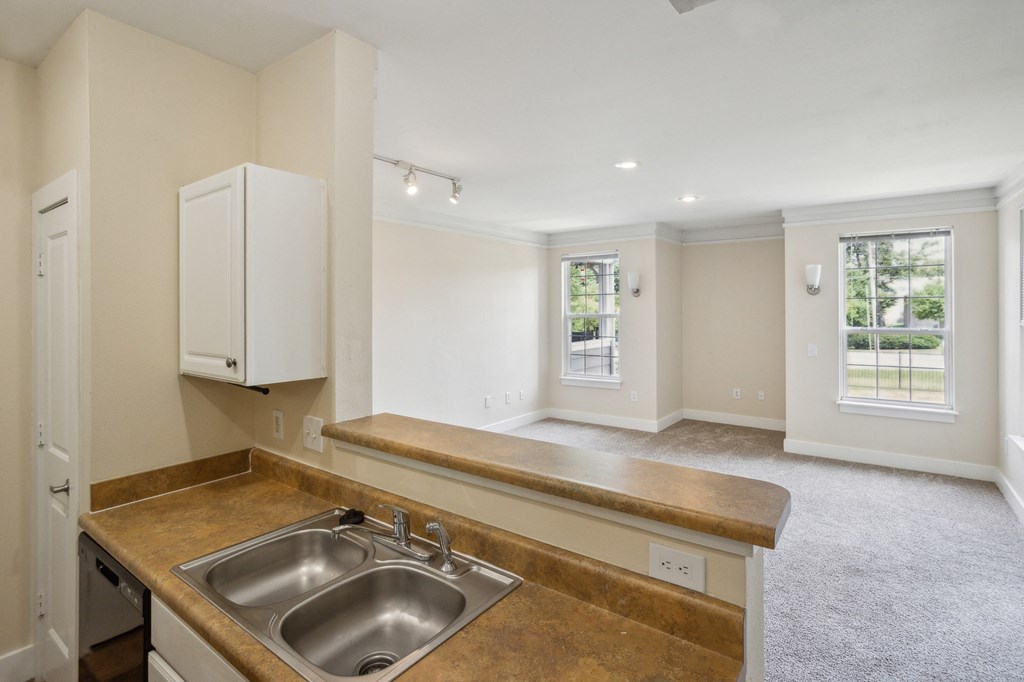 a kitchen and living room with a sink and a window at Province of Briarcliff Apartments, Kansas City, MO, 64118