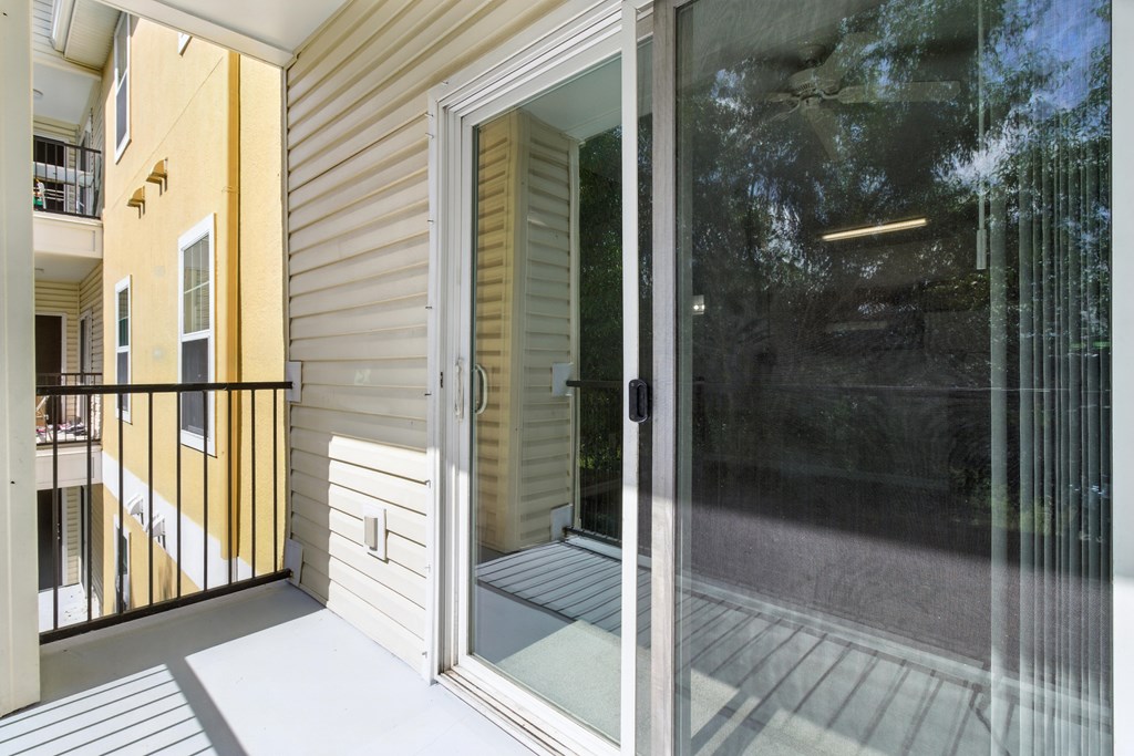 A glass door with a reflection of a building in the background.