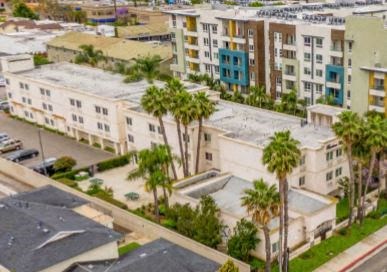 an aerial view of a city with buildings and palm trees