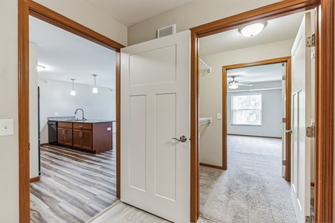 an open kitchen and living room with a white door