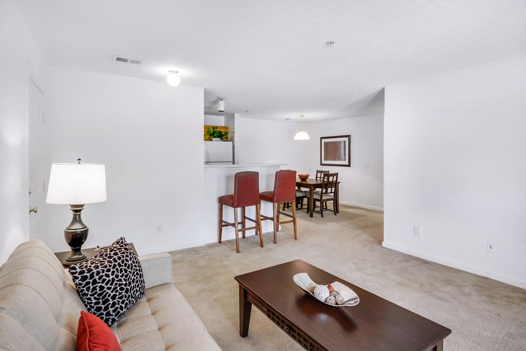 a living room and dining room with a couch and a table