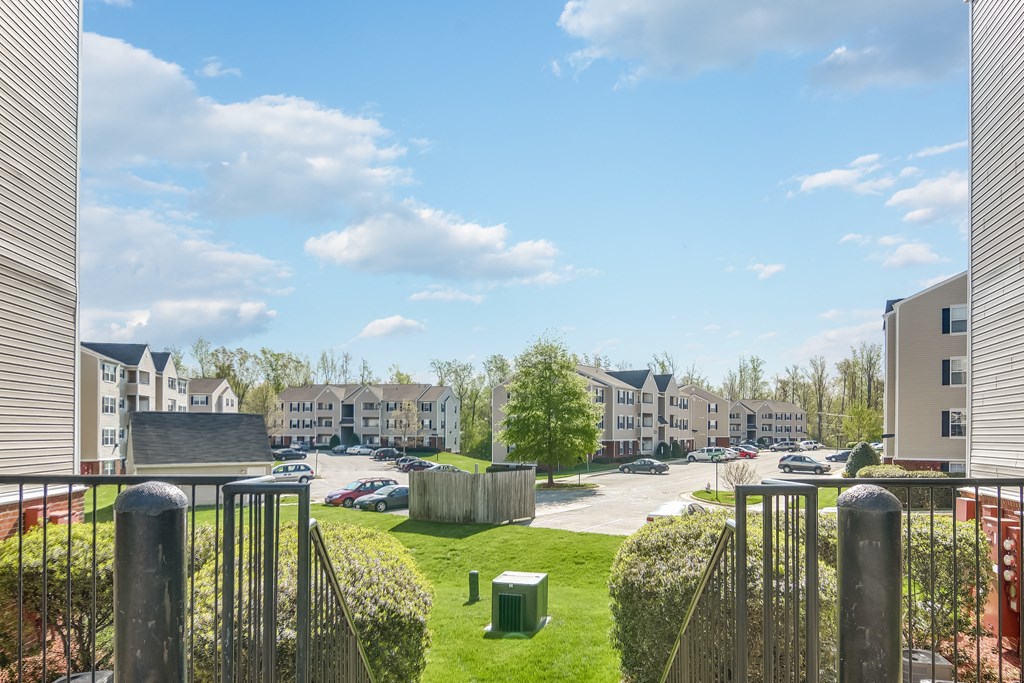 a view of a park with apartments in the background