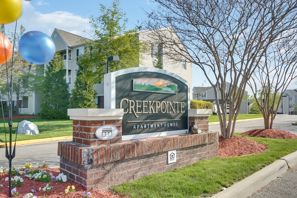 the sign in front of the pointe apartment building