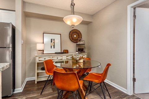 a dining room with a glass table and chairs