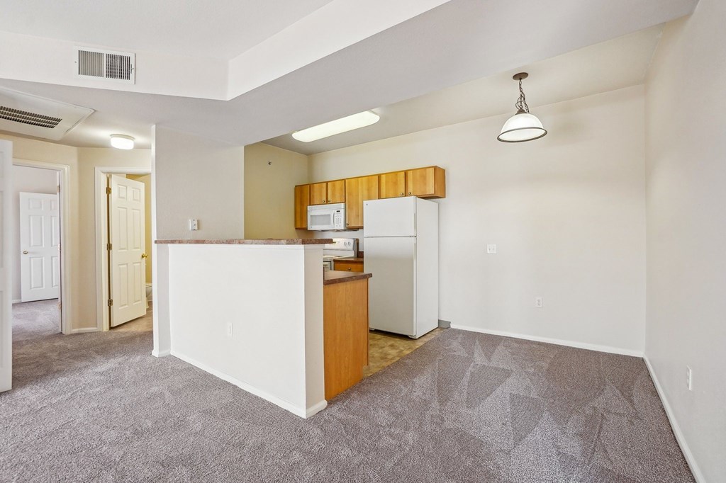 A kitchen area with a white counter and a microwave. at Stetson Meadows Apartments, Colorado Springs, CO