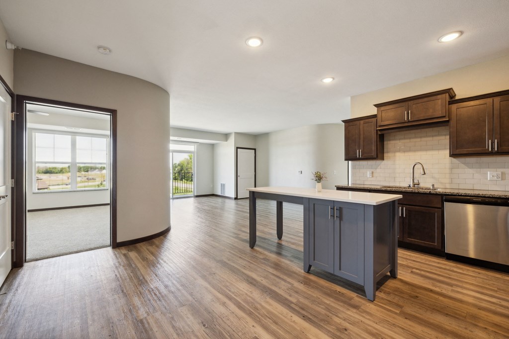 an open kitchen and living room with a large island in the middle