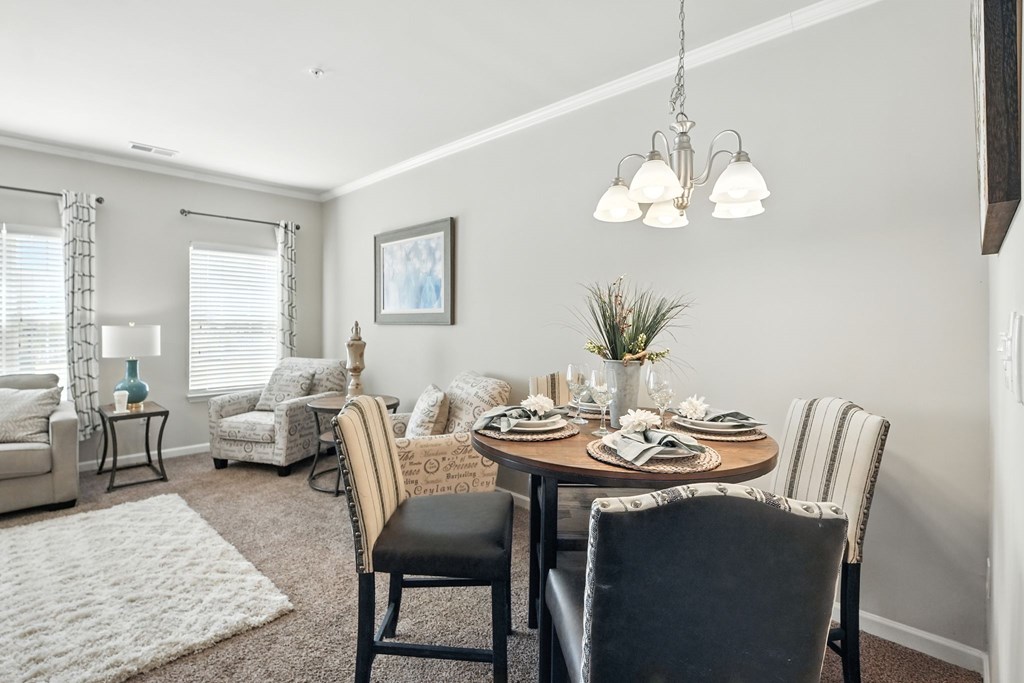 A dining room with a table set for a meal.