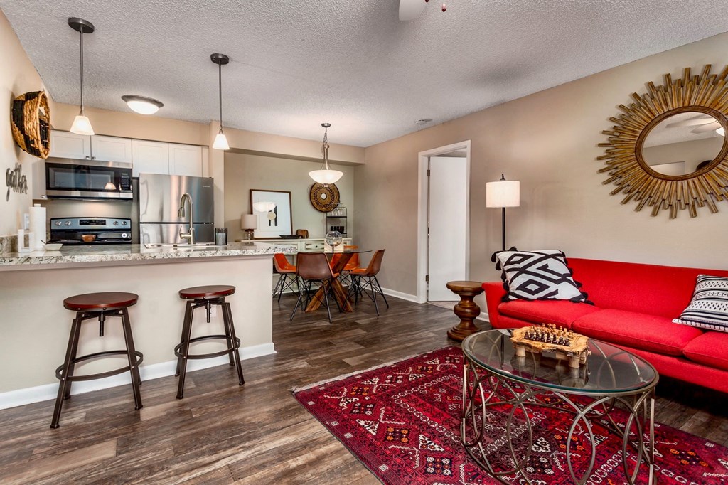 a living room with a couch and a bar and a kitchen