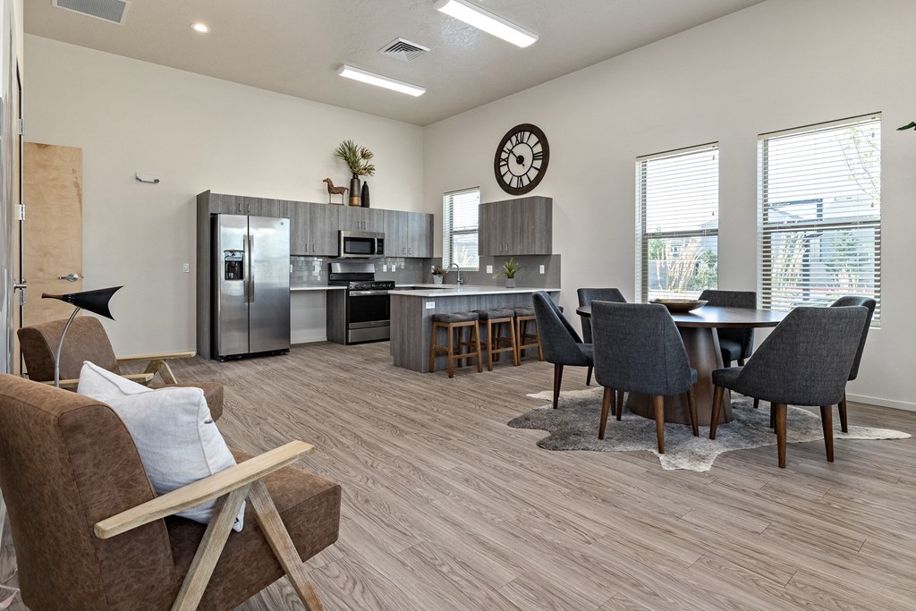 an open living room with a kitchen and a table with chairs