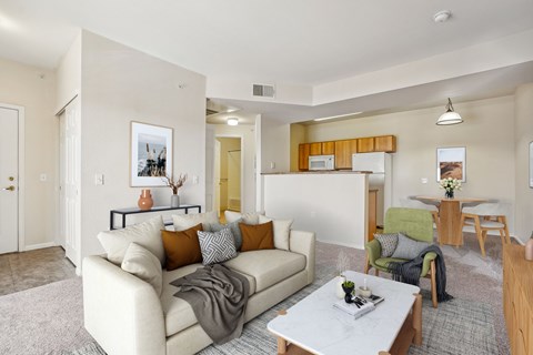 A living room with a white couch and a coffee table.