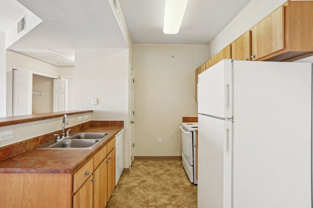 A kitchen with a white refrigerator and brown countertops. at Stetson Meadows Apartments, Colorado Springs, CO, 80922