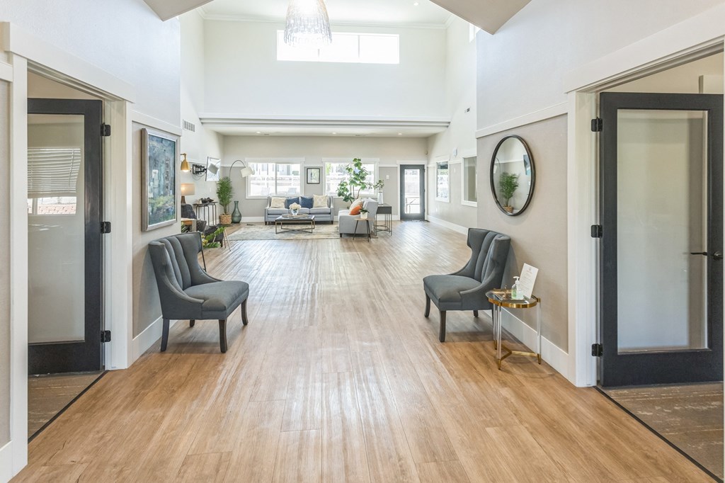 a large living room with a hard wood floor and doors