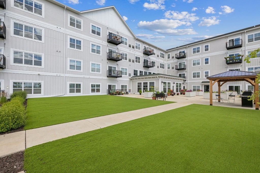 a large green lawn in front of an apartment building at The Hendrickson, Minnesota, 55113
