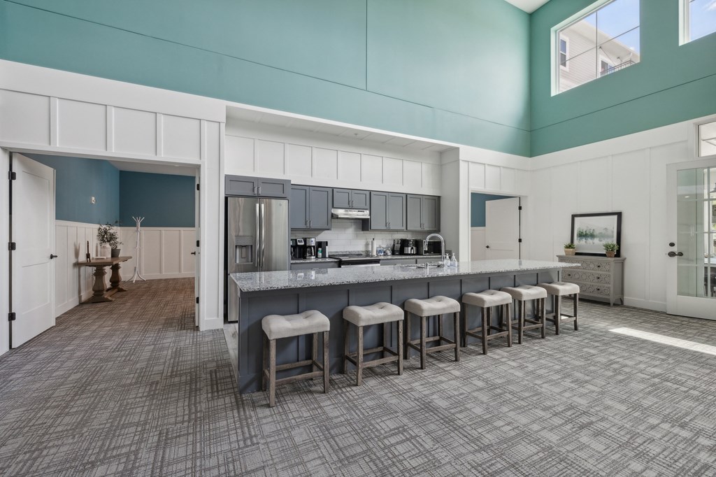 a large kitchen with a long island with bar stools at The Hendrickson, Falcon Heights, 55113