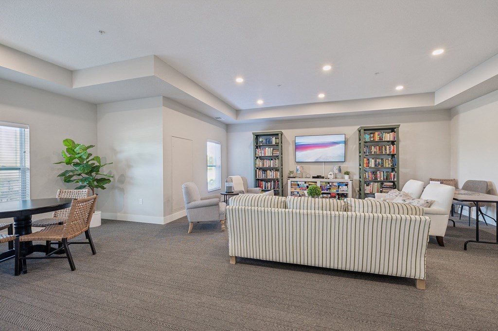 a living room with a couch and a table with chairs at The Hendrickson, Falcon Heights, MN