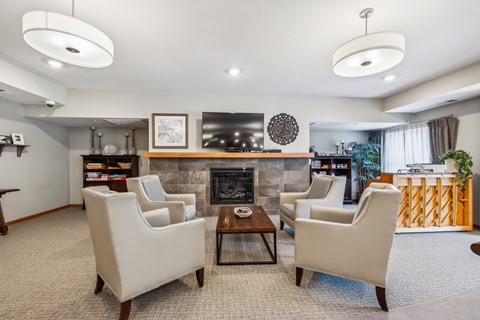 a living room with couches and chairs and a fireplace