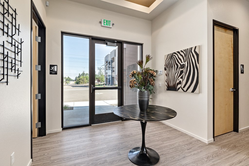 a lobby with a table and a zebra painting on the wall