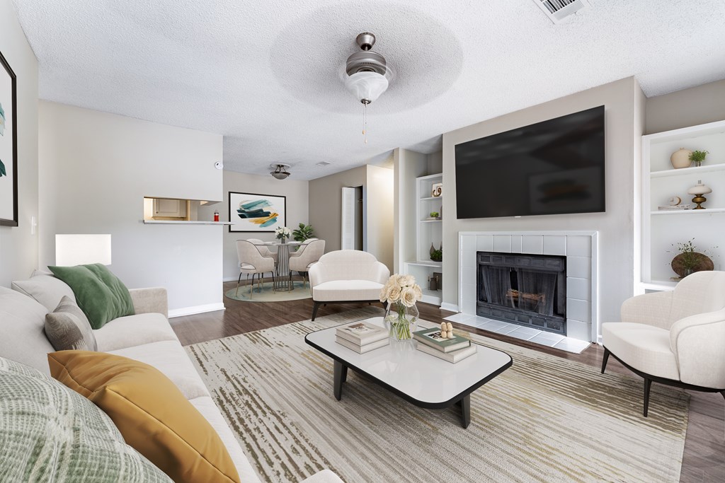 A living room with a fireplace and a television.