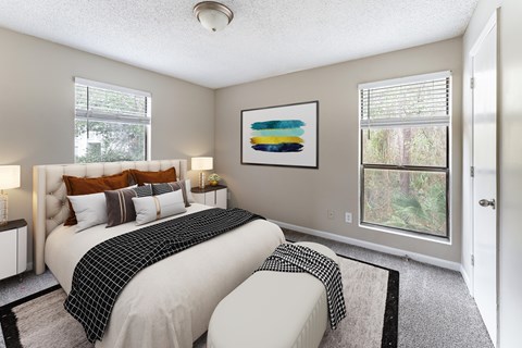 A bedroom with two beds and a painting on the wall.