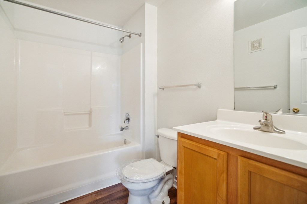 a bathroom with a sink toilet and bath tub