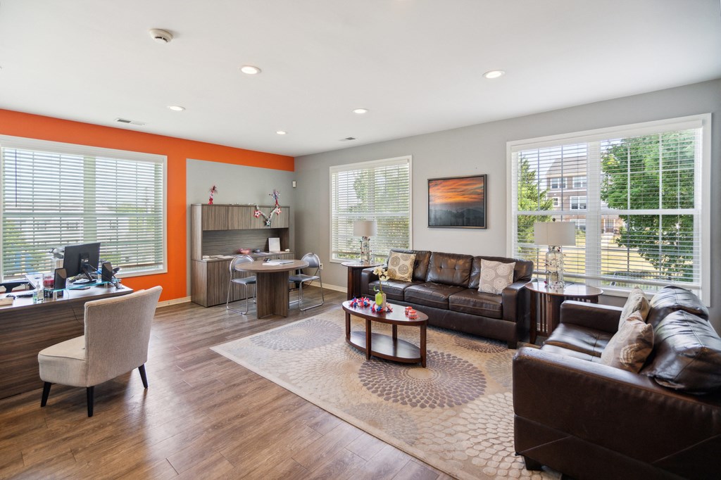 a living room with a couch and a chair and a table