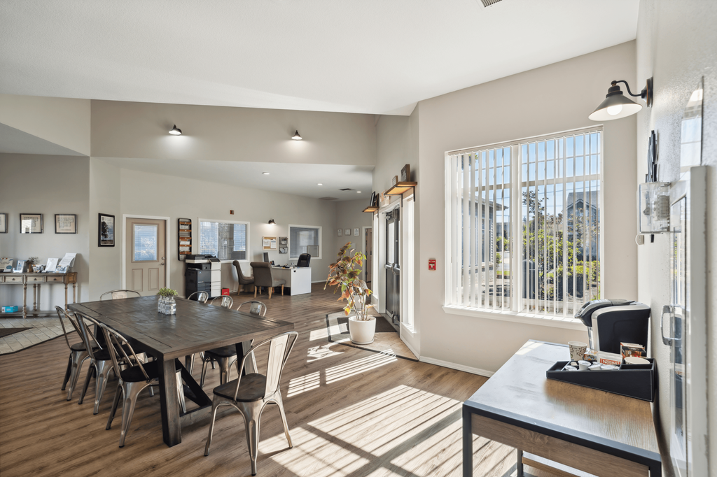 an open living room and dining room with a large window
