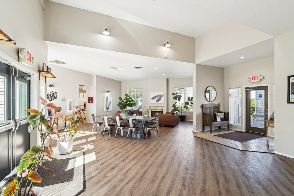 a living room and dining room with a table and chairs