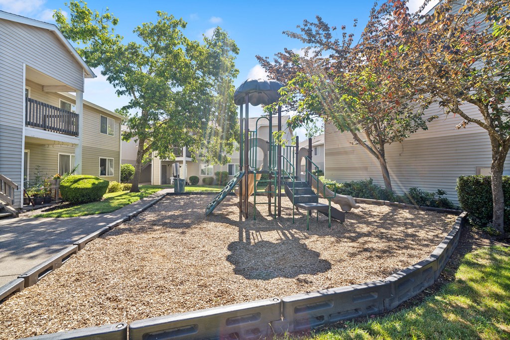 a playground with a swing set in the middle of a yard