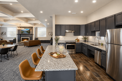 A modern kitchen with a long island and stainless steel appliances.