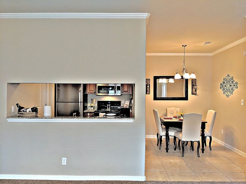 a kitchen and dining room with a table and chairs