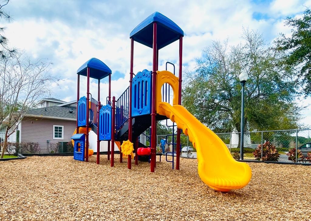 a playground with a blue and yellow swing set
