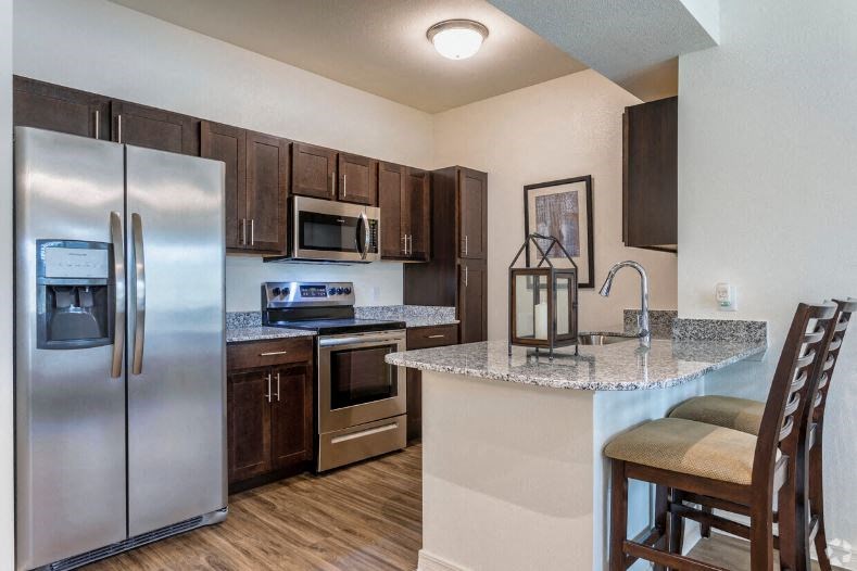 a kitchen with stainless steel appliances and a granite counter top